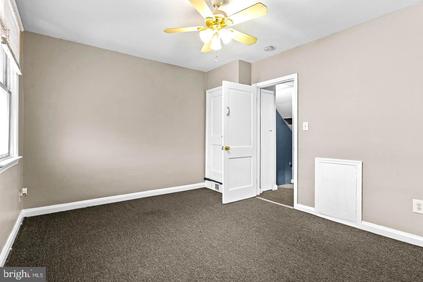 1300 North Potomac Street Baltimore, MD 21213 - Photo 7 of 20 an empty room with a window and a ceiling fan