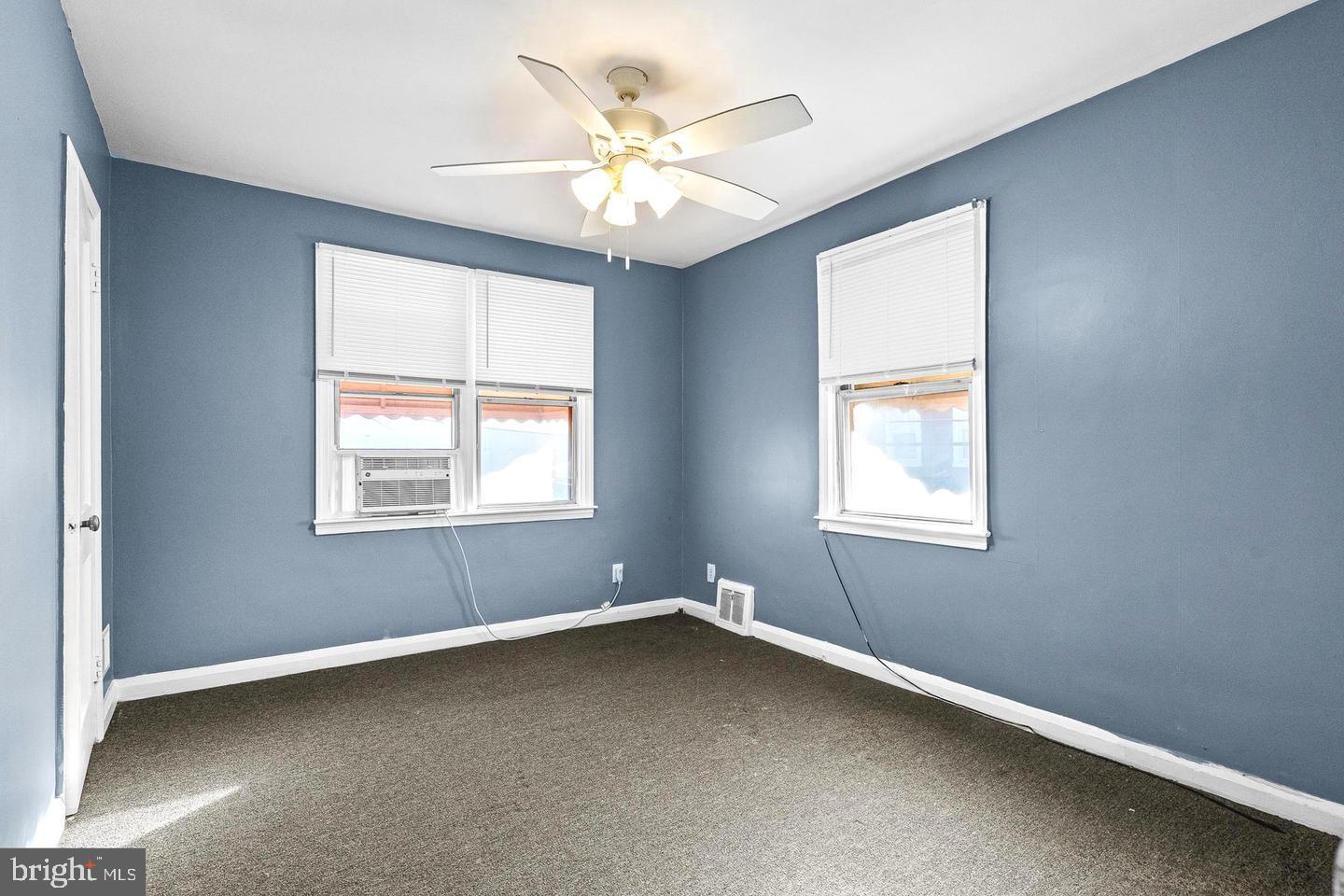 1300 North Potomac Street Baltimore, MD 21213 - Photo 9 of 20 an empty room with windows and chandelier fan