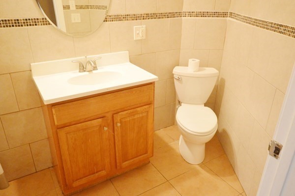 151 Mechanic Street Fitchburg, MA 01420 - Photo 13 of 42 a bathroom with a toilet sink and vanity