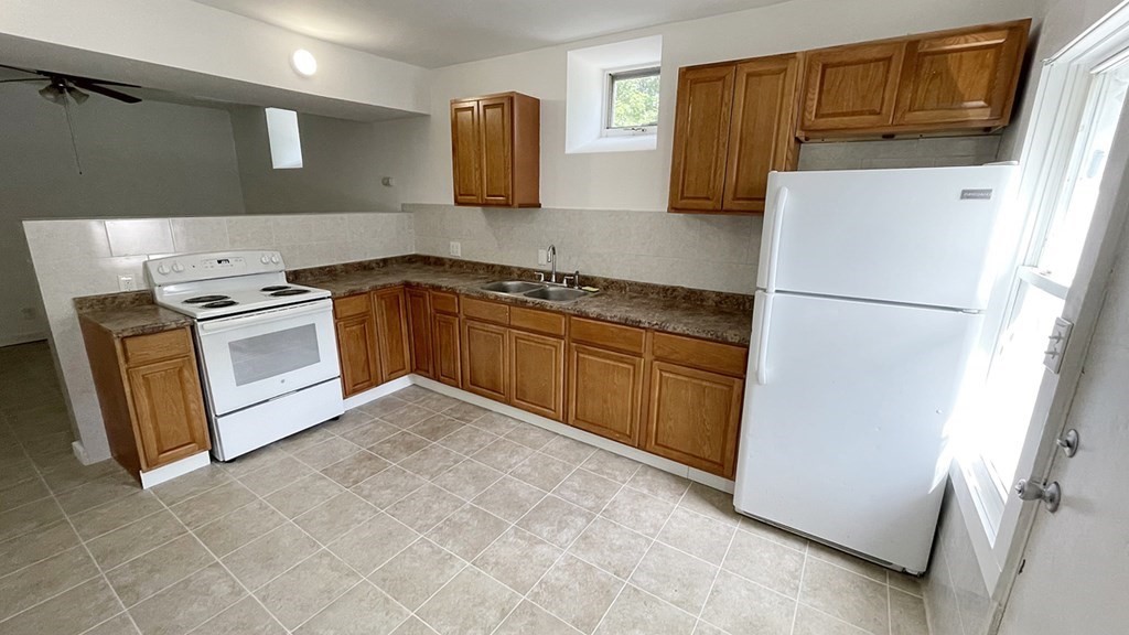 151 Mechanic Street Fitchburg, MA 01420 - Photo 29 of 42 a kitchen with a refrigerator sink and stove