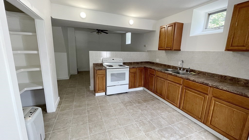 151 Mechanic Street Fitchburg, MA 01420 - Photo 30 of 42 a kitchen with stainless steel appliances granite countertop a stove and a sink