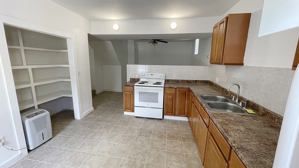151 Mechanic Street Fitchburg, MA 01420 - Photo 31 of 42 a kitchen with a stove and a sink