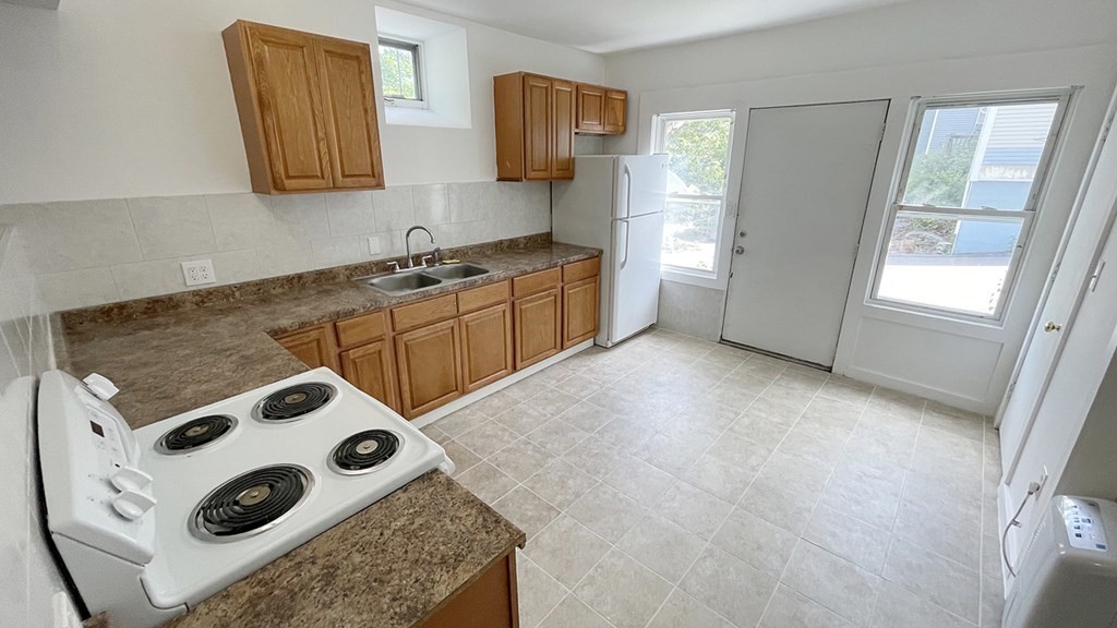 151 Mechanic Street Fitchburg, MA 01420 - Photo 32 of 42 a kitchen with a sink a stove and cabinets