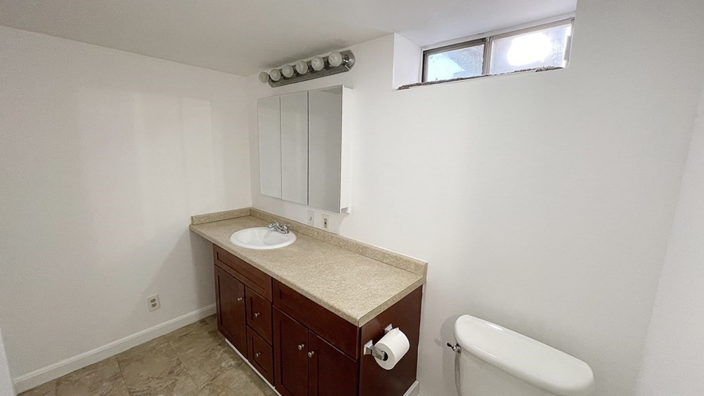 151 Mechanic Street Fitchburg, MA 01420 - Photo 36 of 42 a bathroom with a sink a toilet and vanity