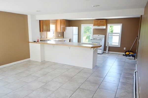 151 Mechanic Street Fitchburg, MA 01420 - Photo 4 of 42 a kitchen with granite countertop a sink a counter top space and cabinets