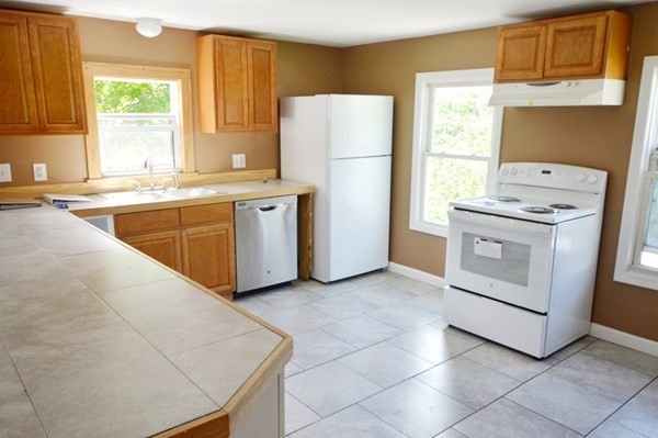 151 Mechanic Street Fitchburg, MA 01420 - Photo 7 of 42 a kitchen with a stove a refrigerator and a sink