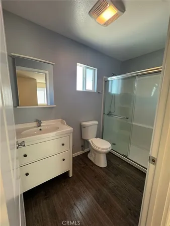 a bathroom with a double vanity sink toilet and shower