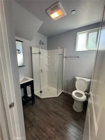 a bathroom with a toilet and a shower