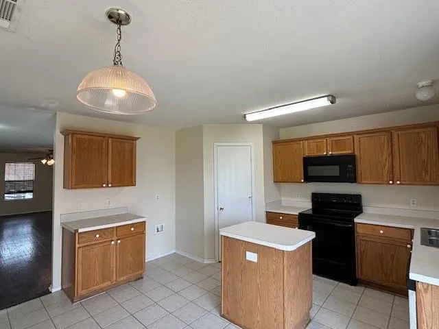 a kitchen with a stove and a refrigerator