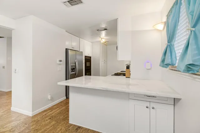 a kitchen with a sink appliances and cabinets