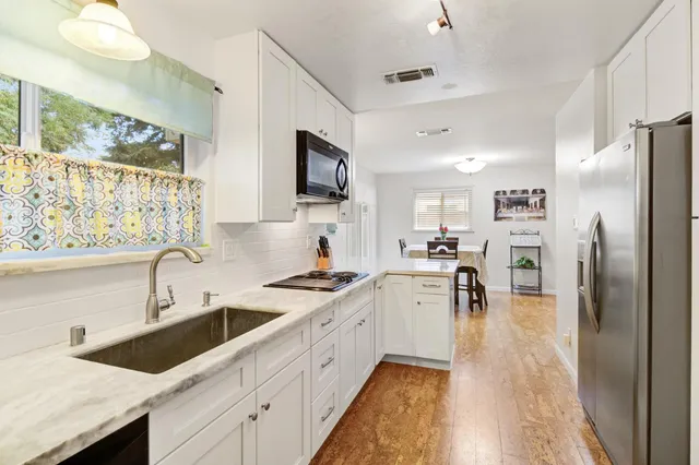 a bathroom with a sink a mirror and a shower