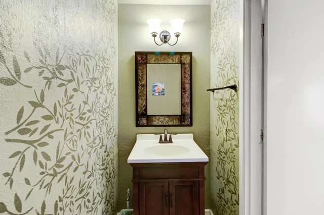 a bedroom with a bed a mirror and furniture