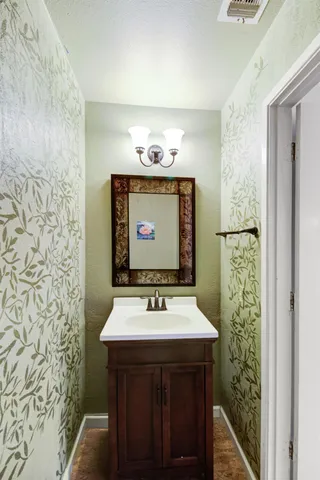 a bedroom with a bed chairs and dresser