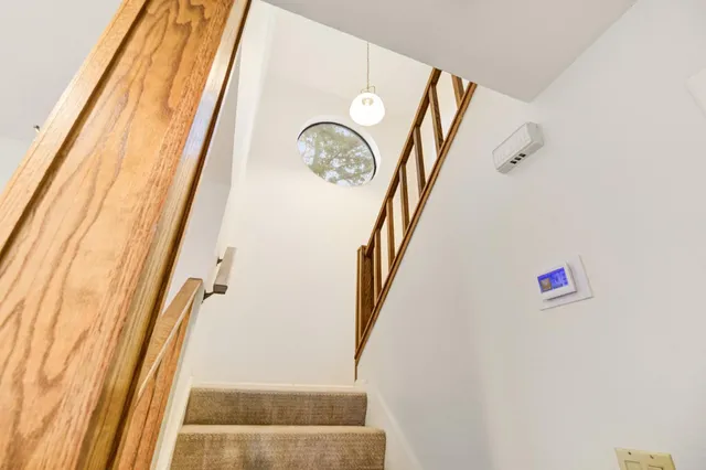 a bedroom with a bed and a mirror