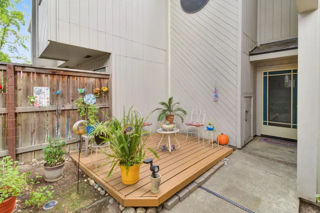 a house with potted plants in front of door