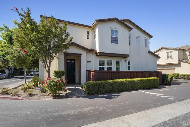 a front view of a house with a yard and a garage