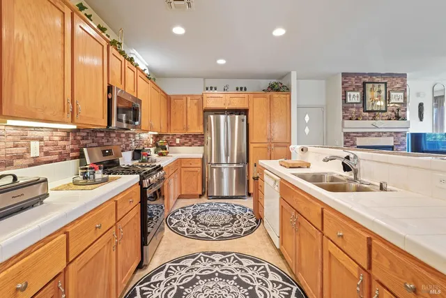 a kitchen with a sink stove and refrigerator