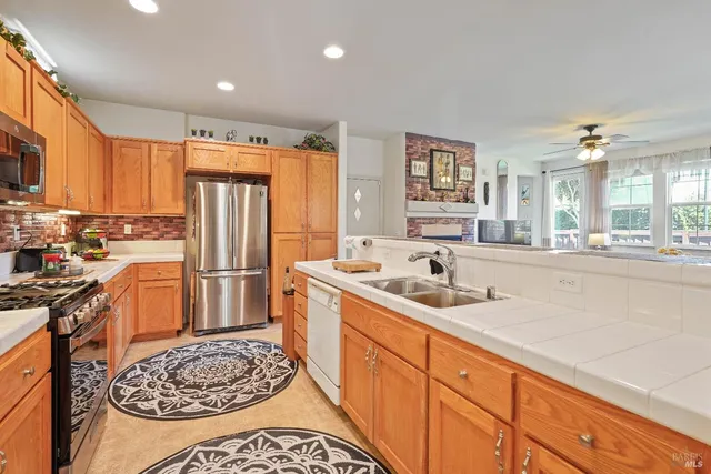 a kitchen with a sink stove and refrigerator