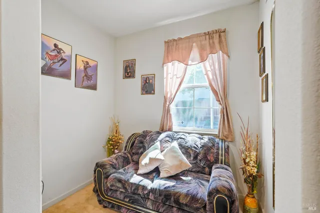 a living room with furniture and a bed