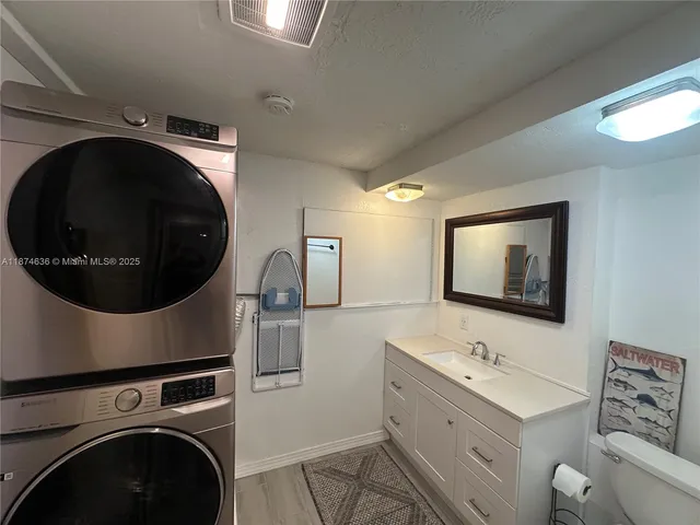 a utility room with sink dryer and washer