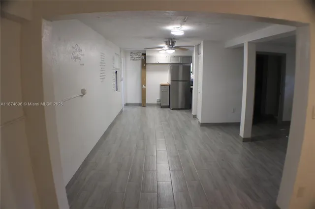 a view of a hallway with wooden floor