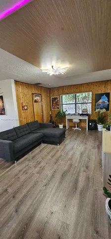 a living room with furniture window and flat screen tv