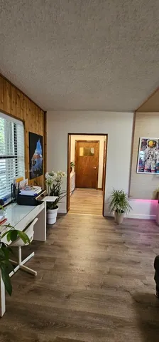 a view of kitchen with kitchen island microwave and stove in it