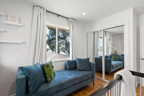 a bedroom with a bed and a painting on the wall