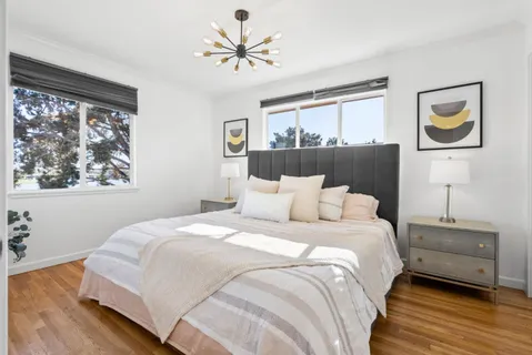 a bedroom with a bed and a chandelier