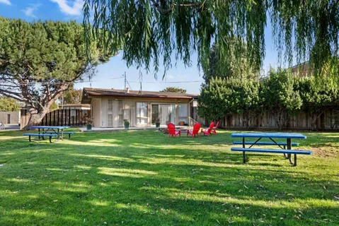 a view of yard with swimming pool and green space