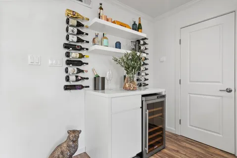 a living room with stainless steel appliances kitchen island granite countertop furniture and a view of kitchen