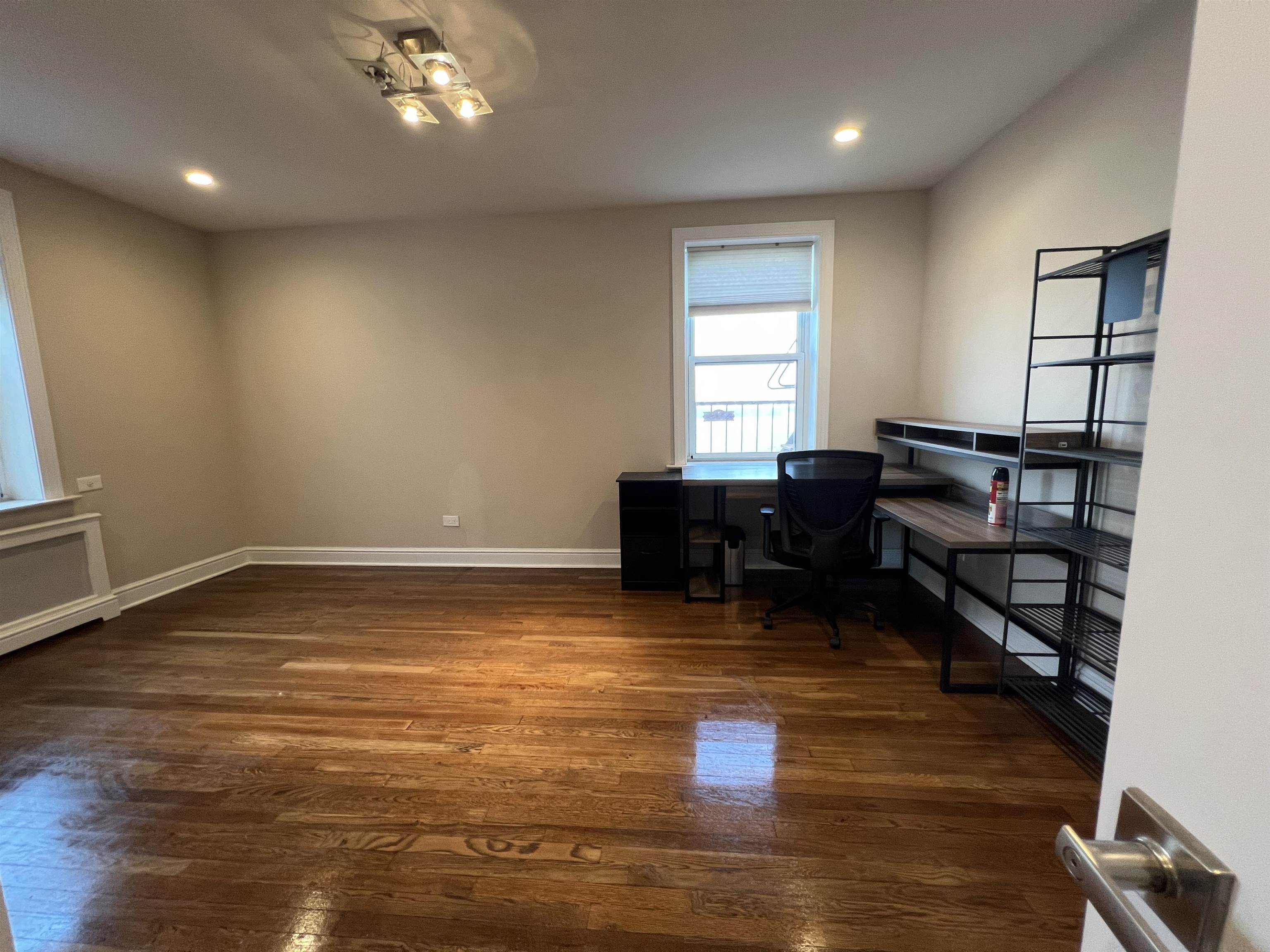 8550 Boulevard East, Unit 3C North Bergen, NJ 07047 - Photo 12 of 25 a view of empty room with wooden floor and fan