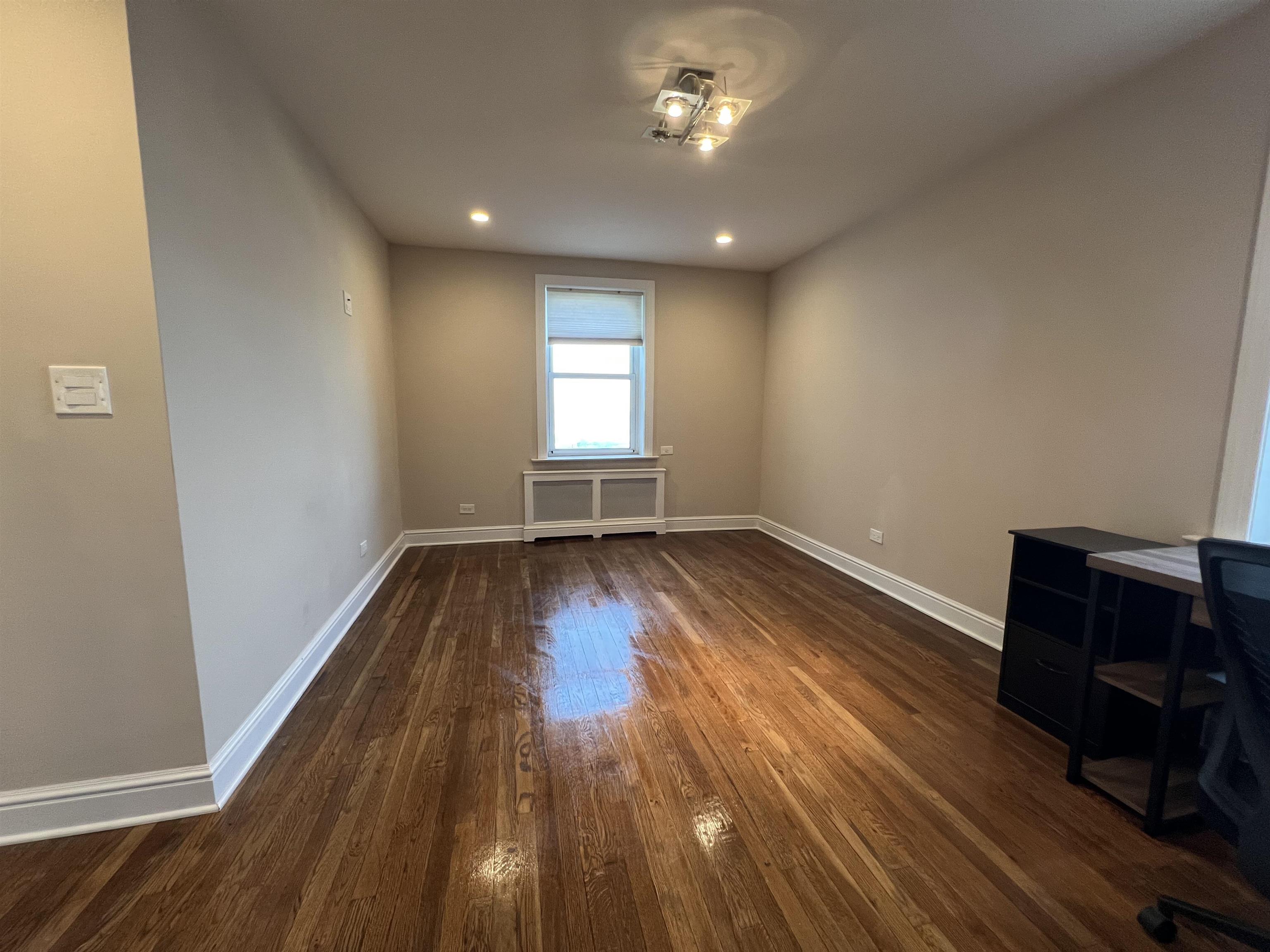 8550 Boulevard East, Unit 3C North Bergen, NJ 07047 - Photo 13 of 25 wooden floor in an empty room with a window