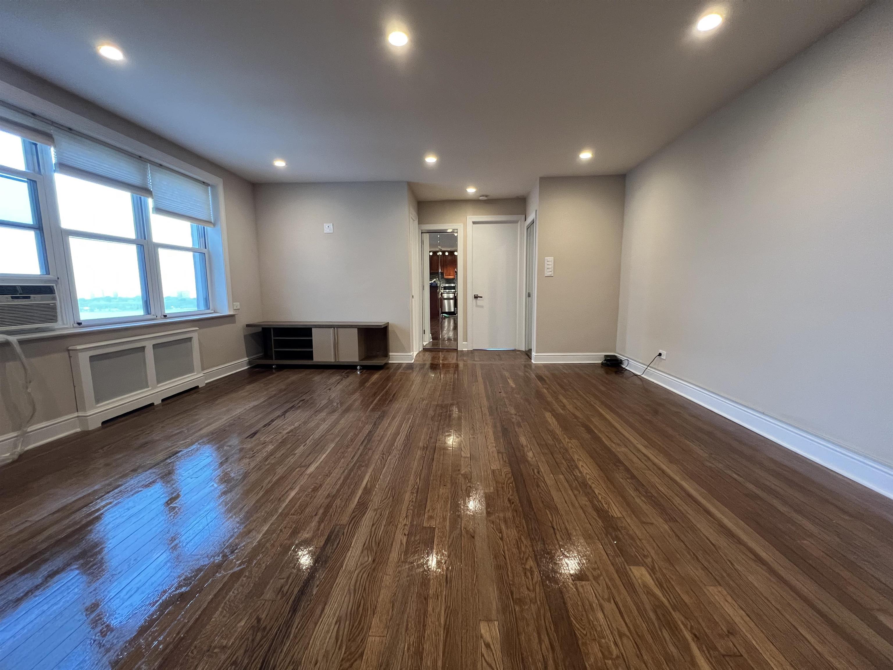 8550 Boulevard East, Unit 3C North Bergen, NJ 07047 - Photo 6 of 25 a view of empty room with wooden floor and fan