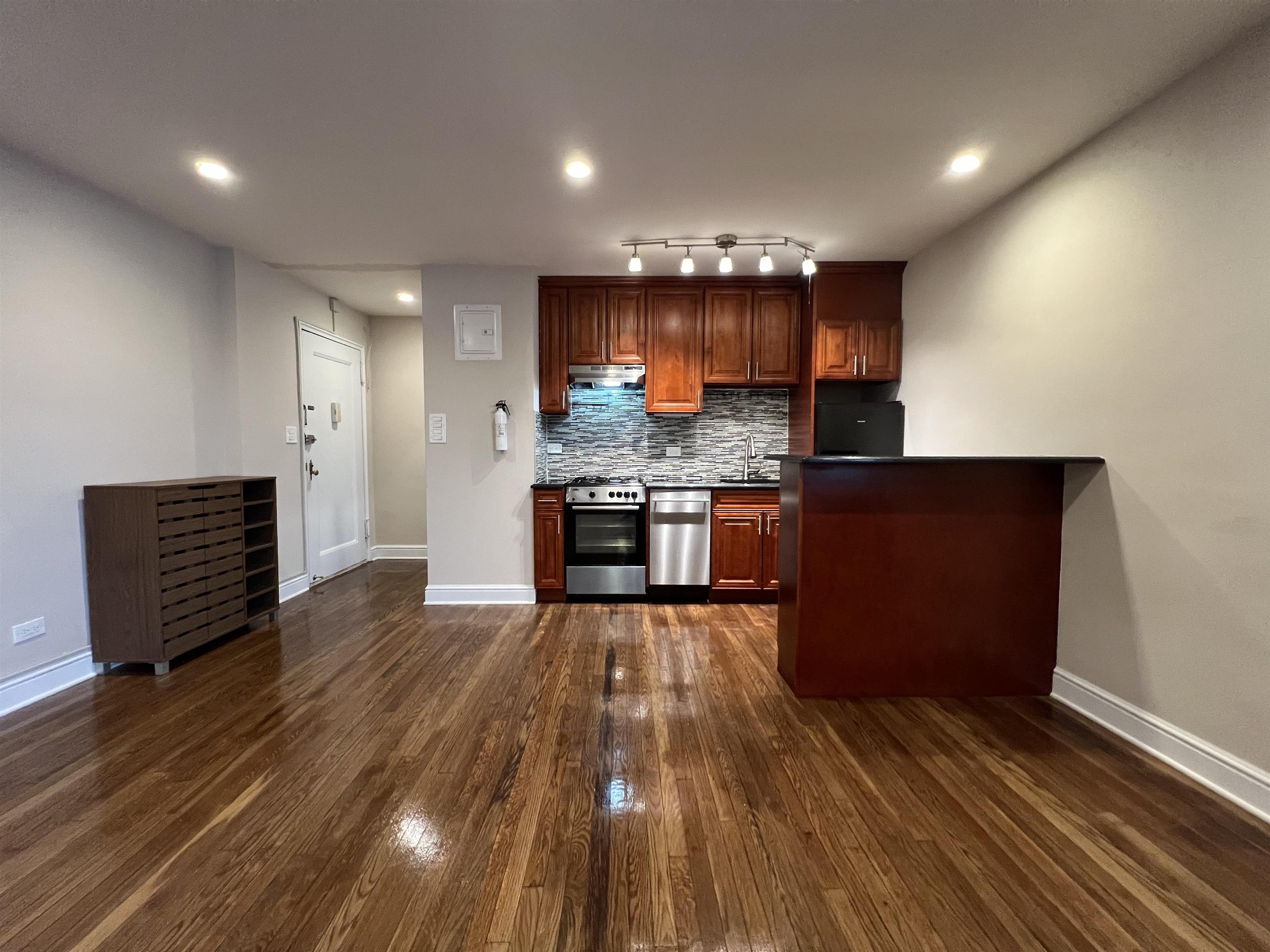 8550 Boulevard East, Unit 3C North Bergen, NJ 07047 - Photo 9 of 25 a kitchen with stainless steel appliances granite countertop a stove and a wooden floors