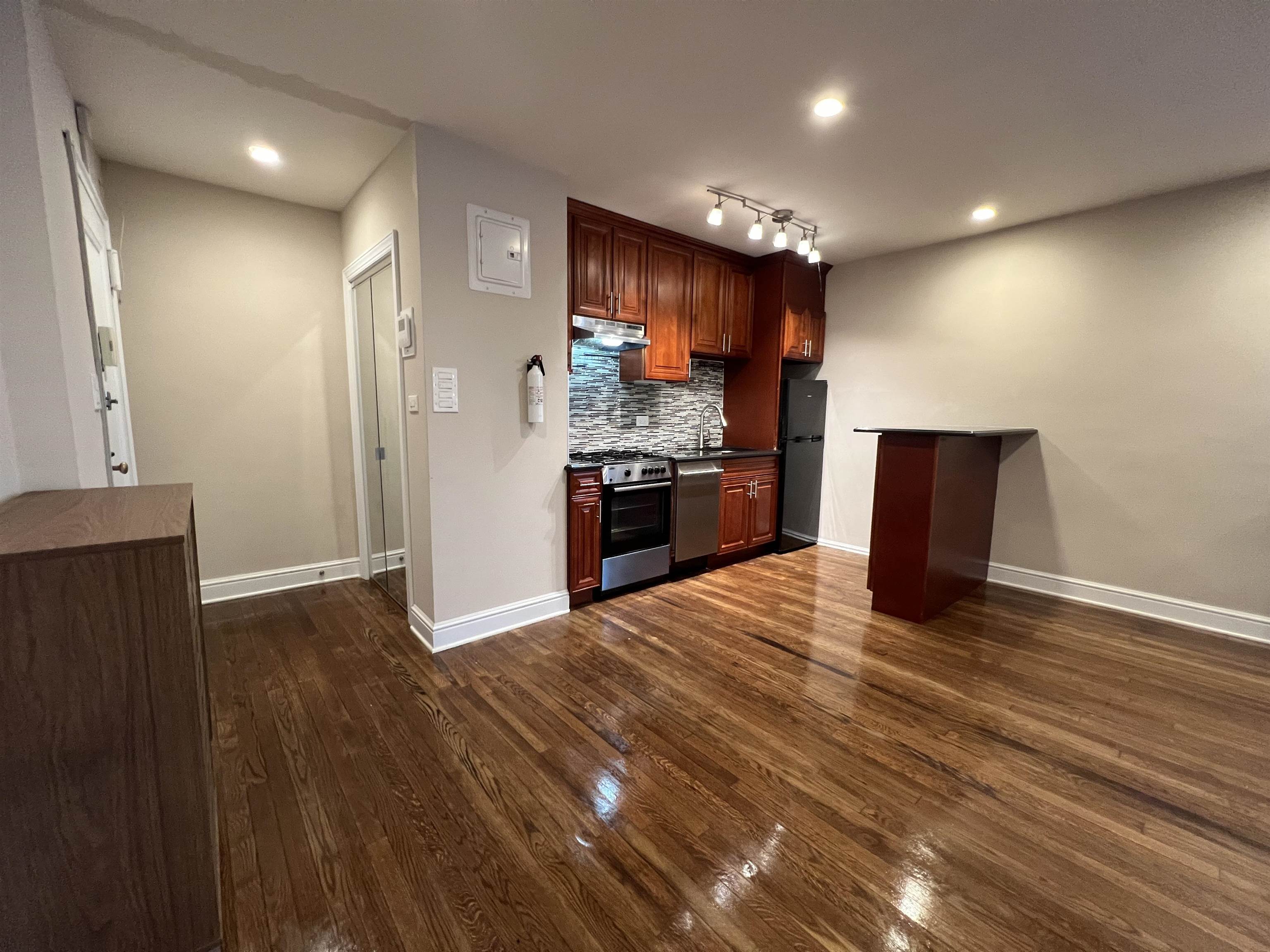 8550 Boulevard East, Unit 3C North Bergen, NJ 07047 - Photo 10 of 25 an empty room with wooden floor and stainless steel appliances
