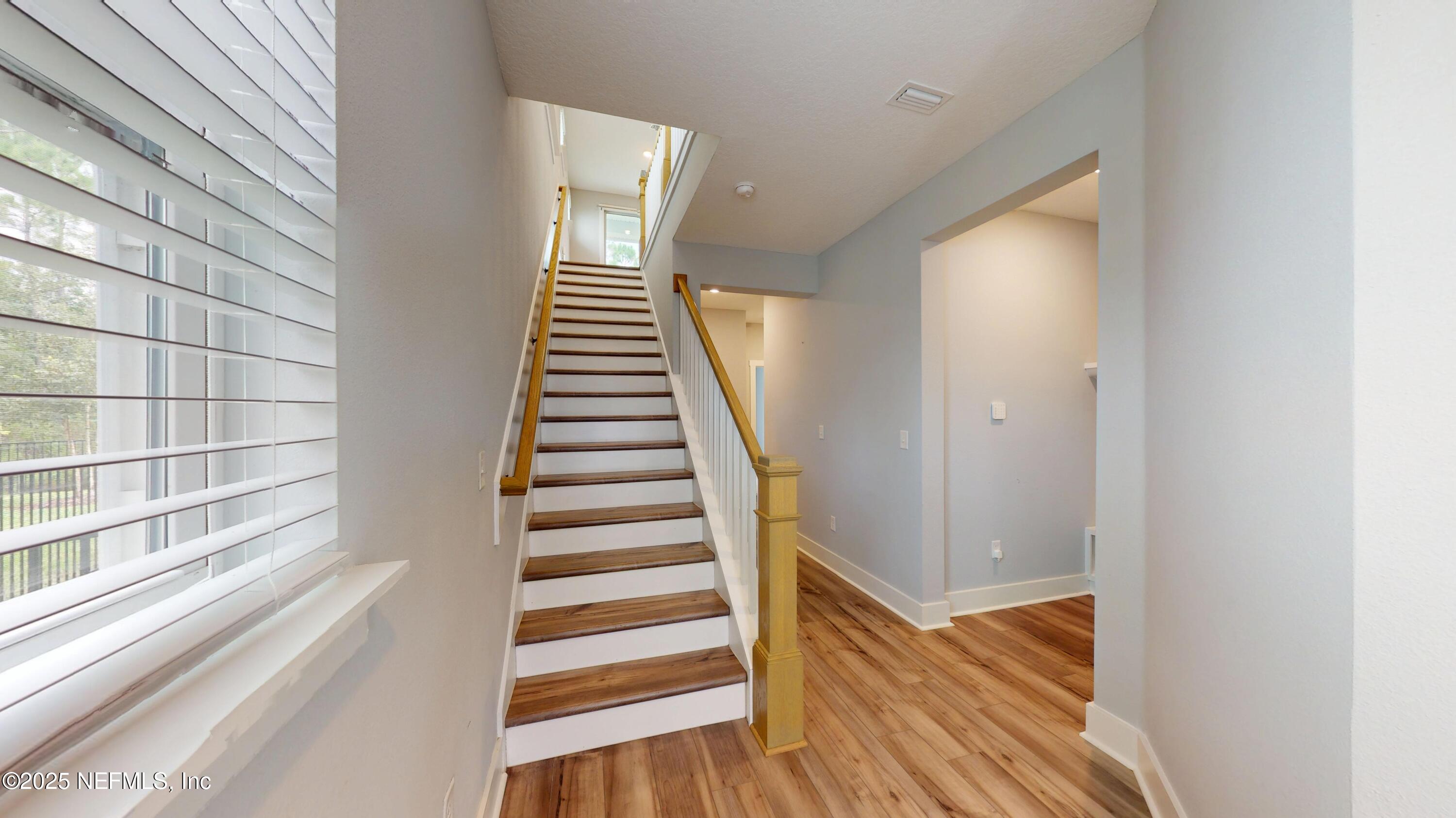 9921 Element Road Jacksonville, FL 32256 - Photo 11 of 37 a view of a hallway with wooden floor and entryway