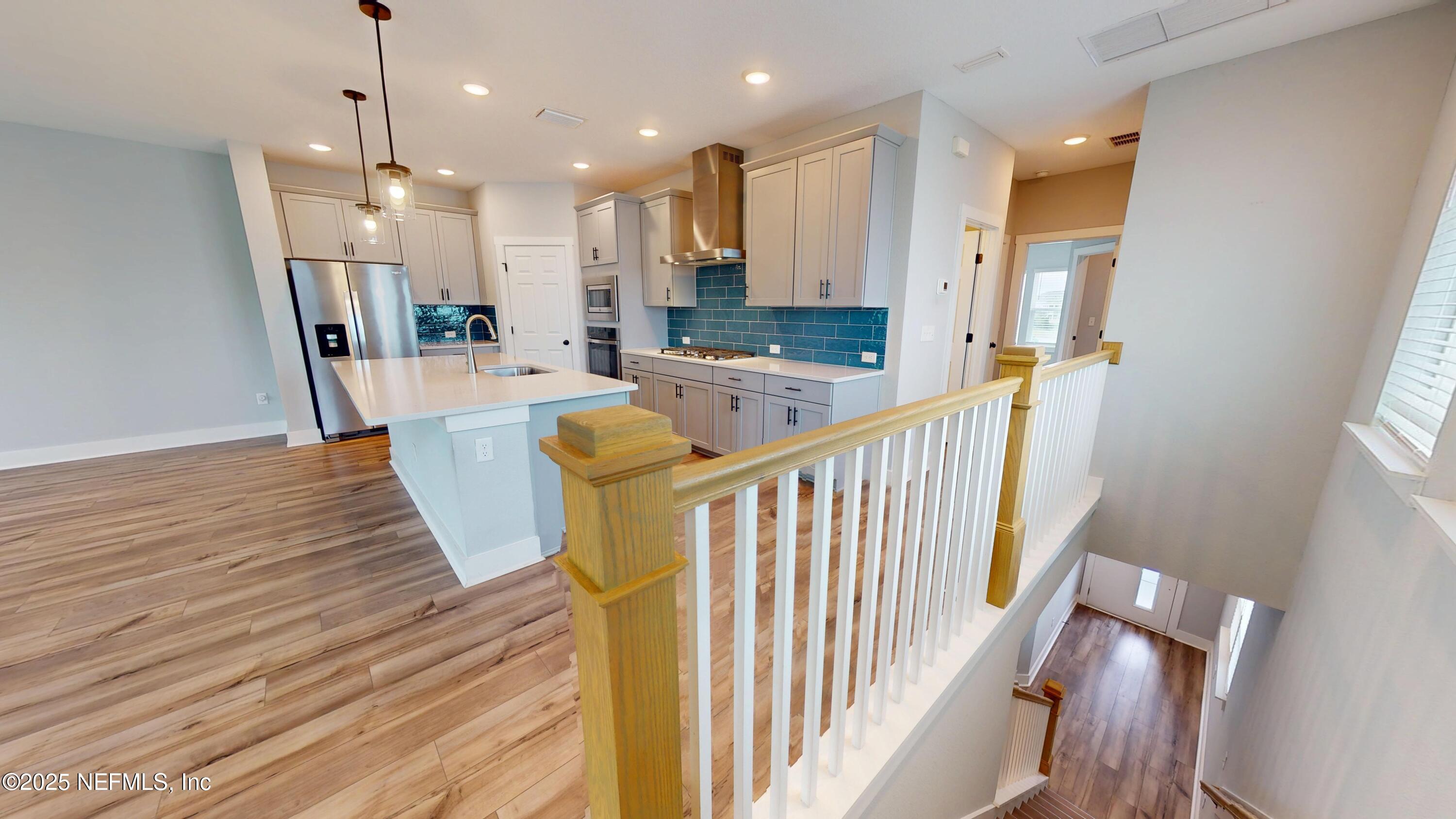 9921 Element Road Jacksonville, FL 32256 - Photo 12 of 37 a view of a kitchen with wooden floor and staircase