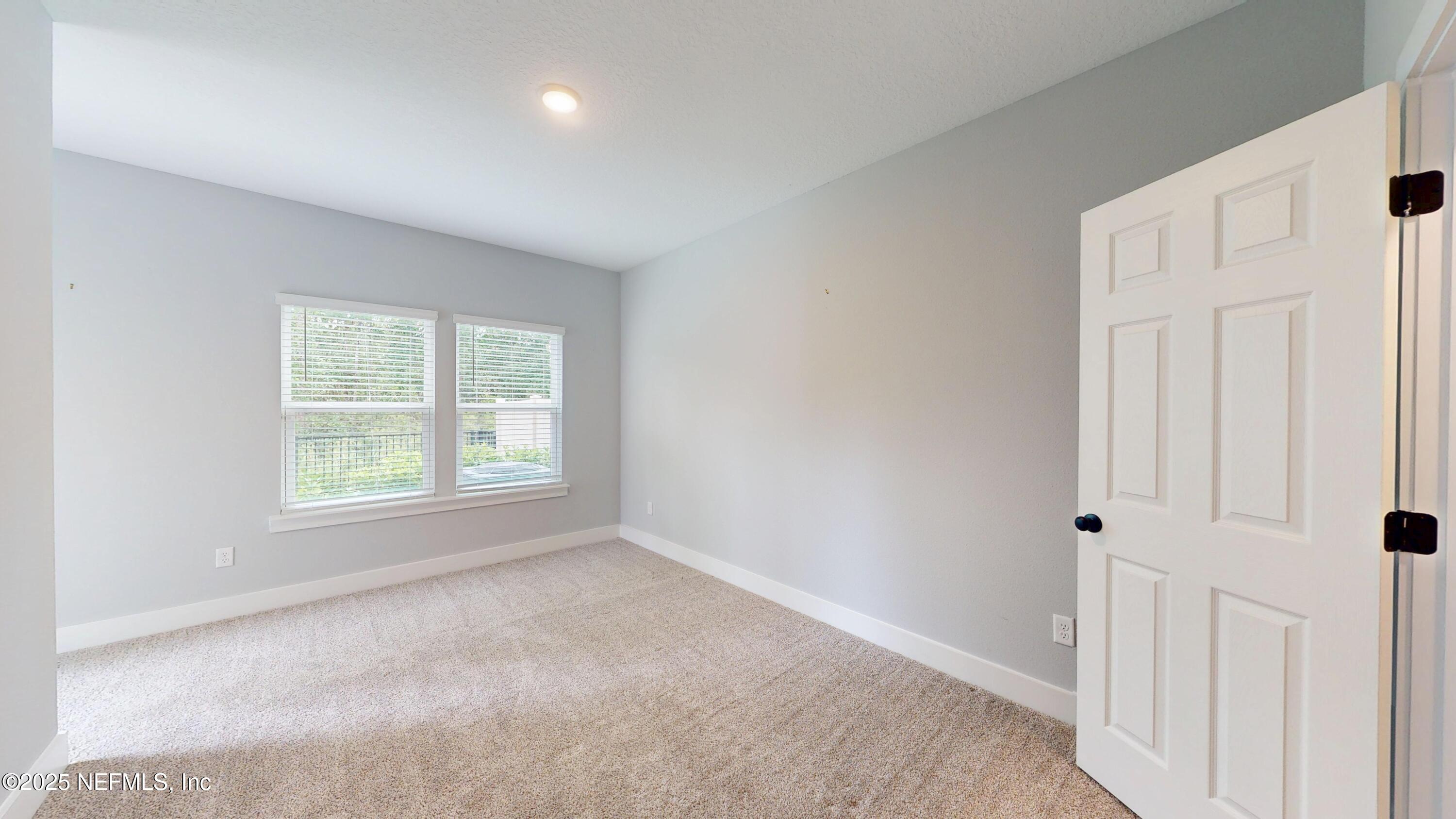 9921 Element Road Jacksonville, FL 32256 - Photo 14 of 37 an empty room with a window