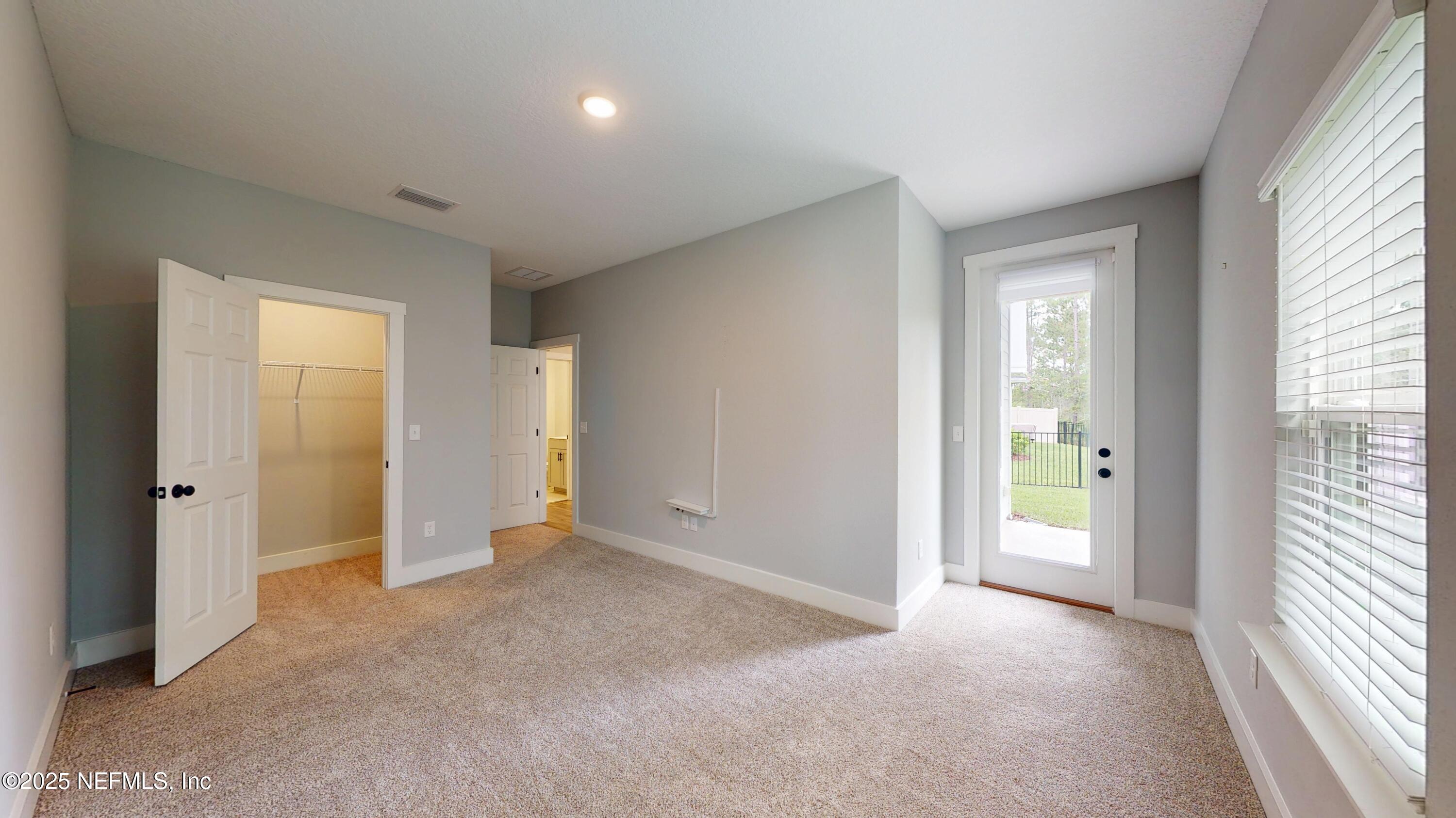 9921 Element Road Jacksonville, FL 32256 - Photo 15 of 37 an empty room with closet and a window