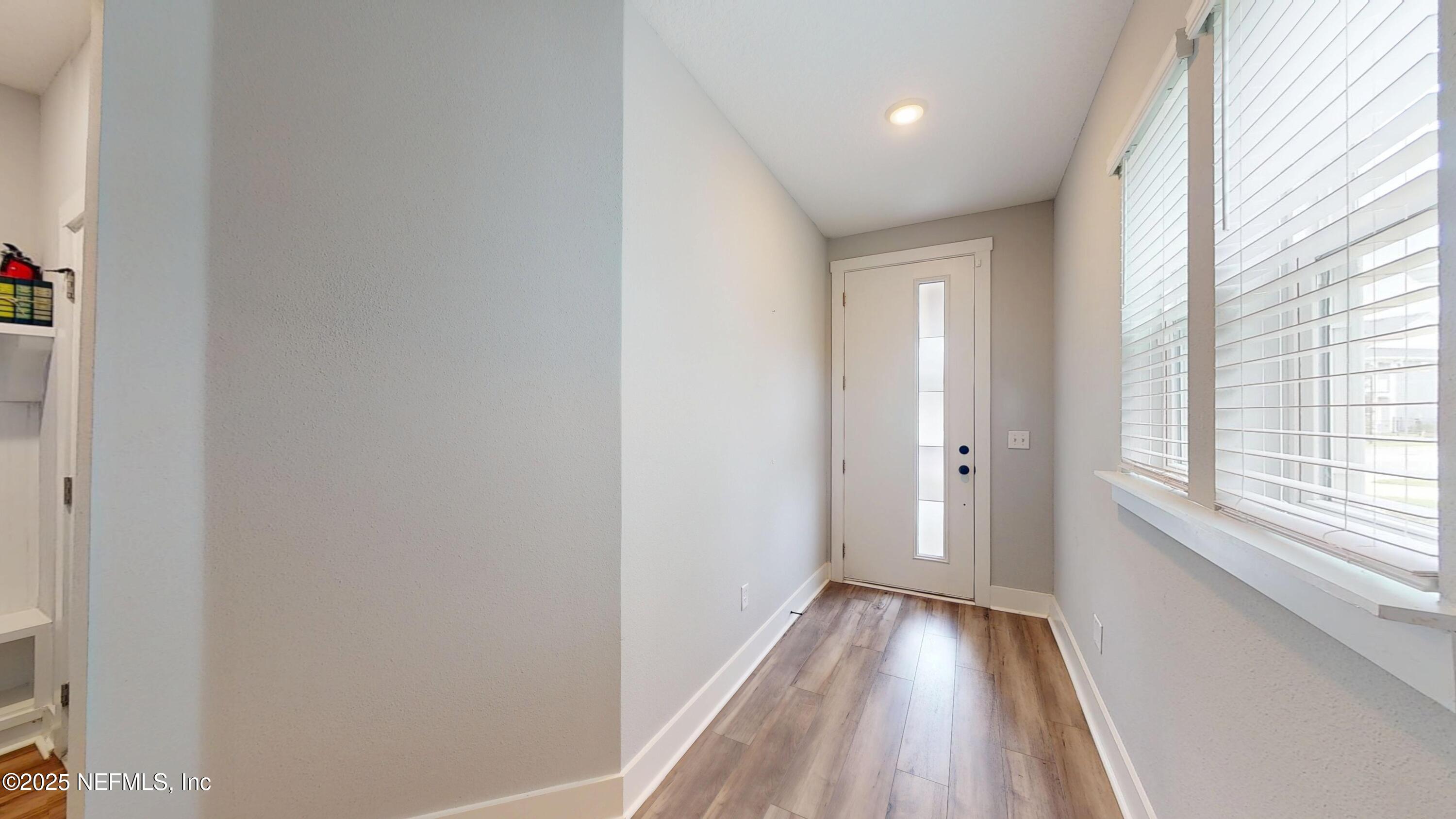 9921 Element Road Jacksonville, FL 32256 - Photo 2 of 37 a view of a room with wooden floor and window