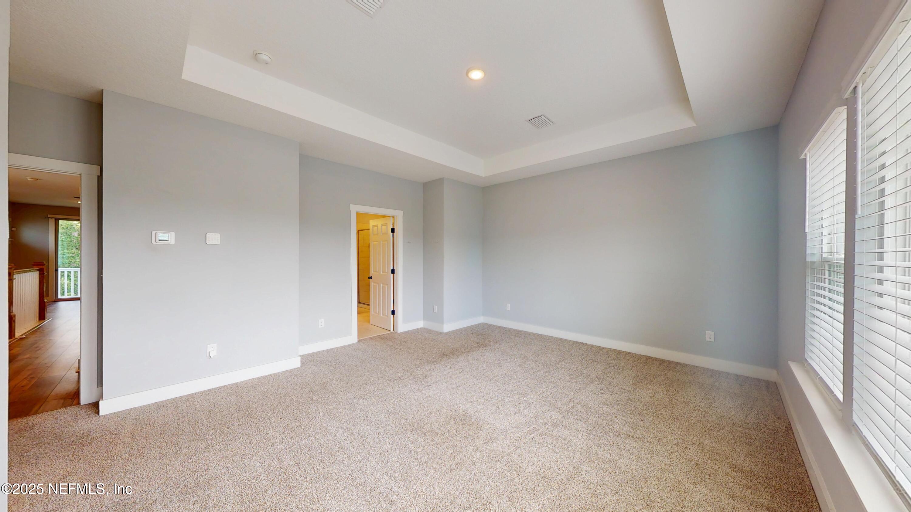 9921 Element Road Jacksonville, FL 32256 - Photo 23 of 37 wooden floor in an empty room with a window