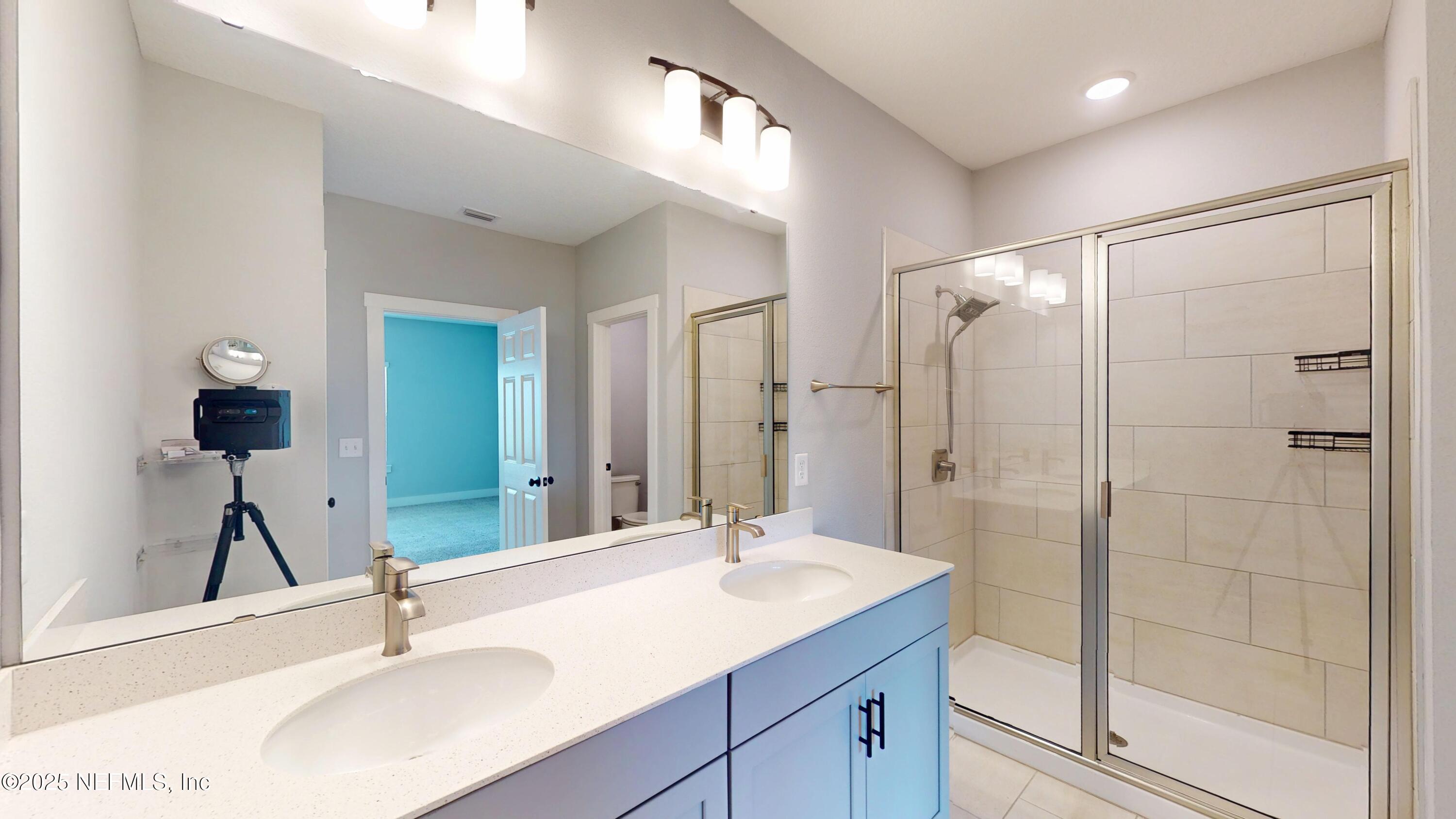 9921 Element Road Jacksonville, FL 32256 - Photo 24 of 37 a bathroom with a sink and a mirror