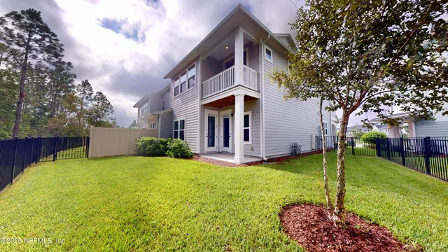 a view of a house with a yard and plants