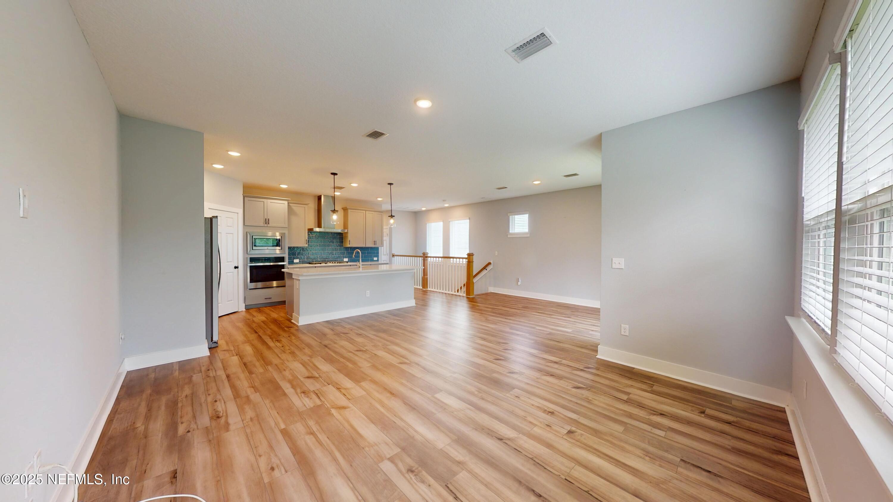 9921 Element Road Jacksonville, FL 32256 - Photo 3 of 37 a view of kitchen and hall with wooden floor