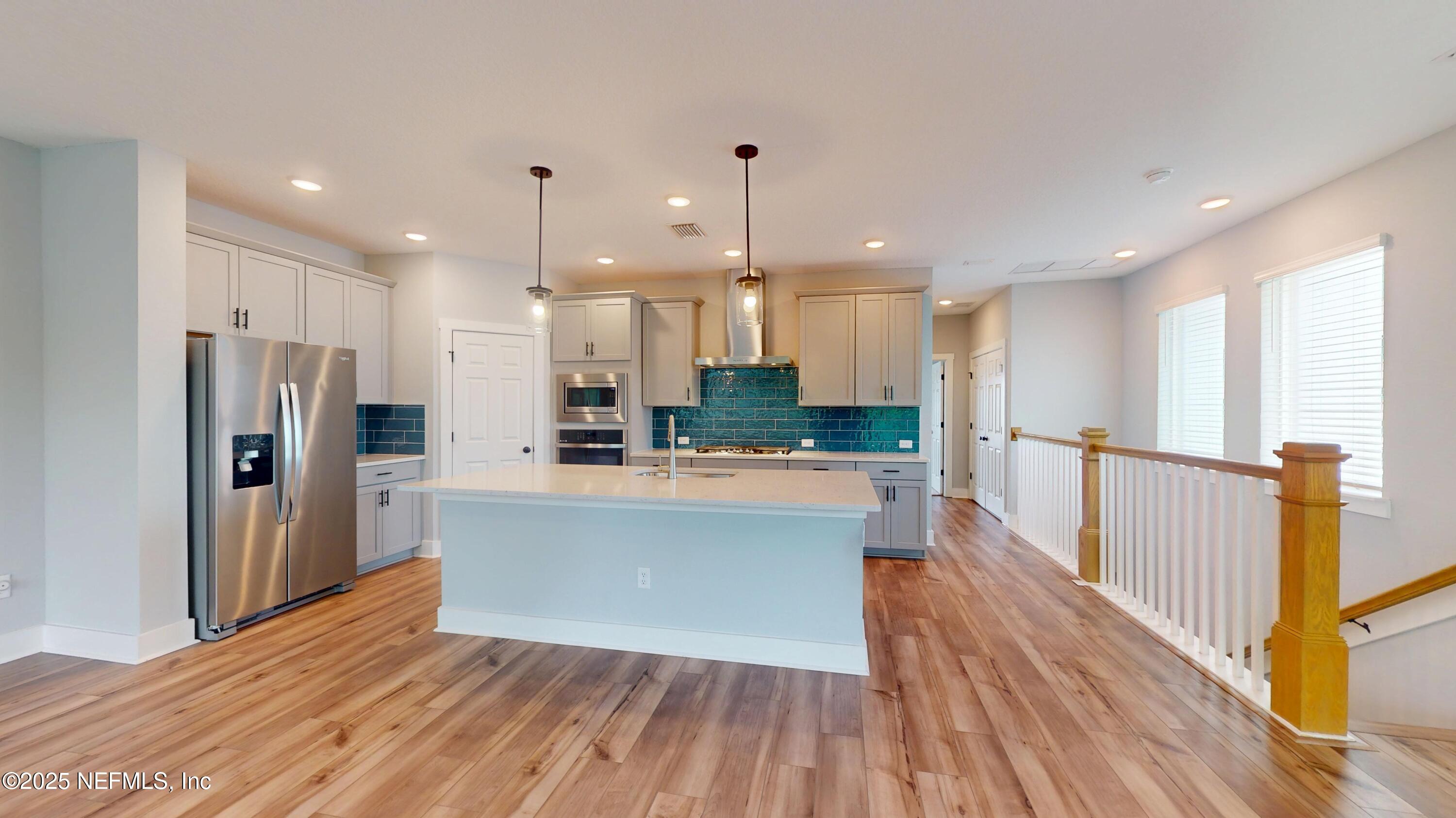 9921 Element Road Jacksonville, FL 32256 - Photo 5 of 37 a large kitchen with large windows and refrigerator