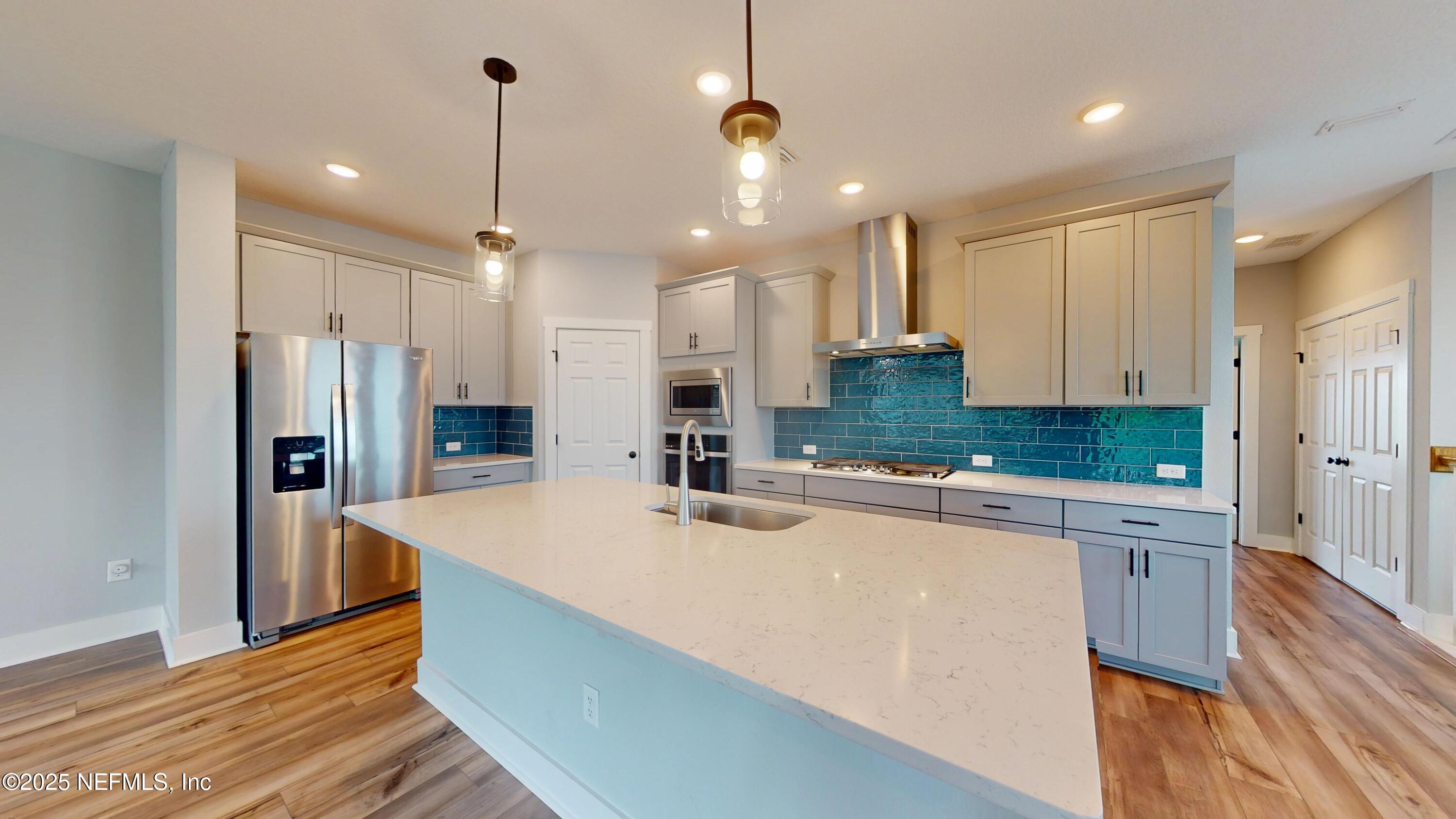 9921 Element Road Jacksonville, FL 32256 - Photo 6 of 37 a kitchen with stainless steel appliances a refrigerator sink and cabinets
