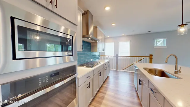 a kitchen with counter top space and stainless steel appliances