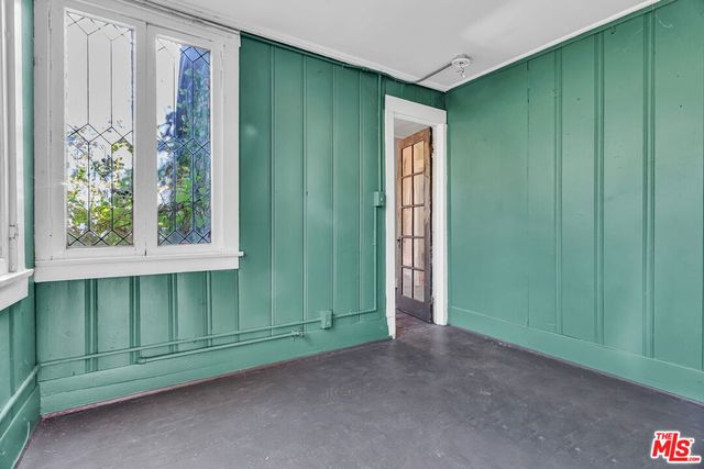 a view of a house with a large window and wooden walls