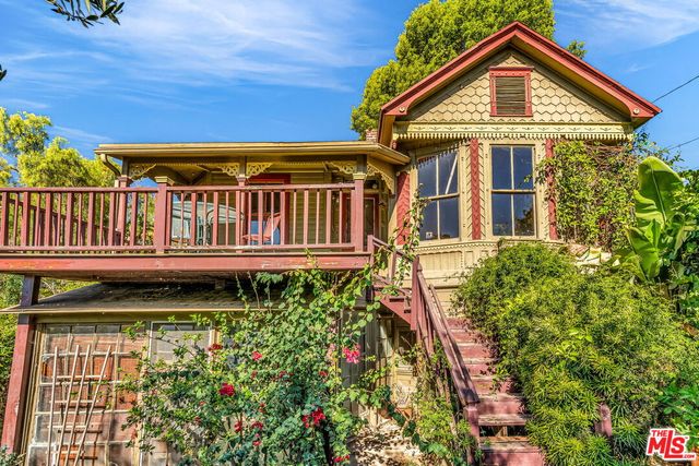 a view of a house with wooden fence